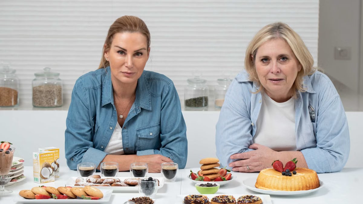 Two women enjoying pastries and coffee indoors, perfect for lifestyle and food stock imagery.