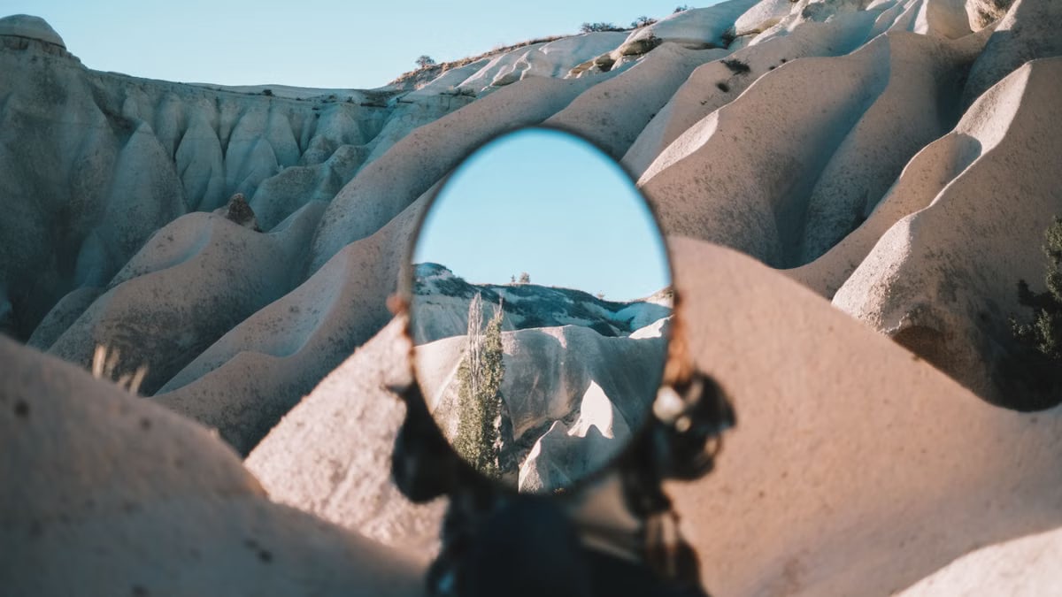 Mirror reflecting unique rock formations in Cappadocia, creating a surreal visual effect.